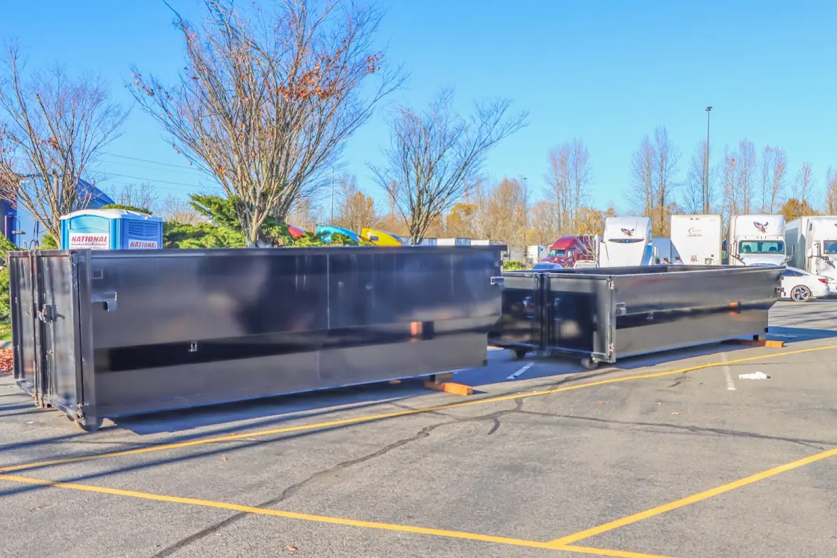 Professional dumpster rental service with roll-off container on residential driveway in Bolivar